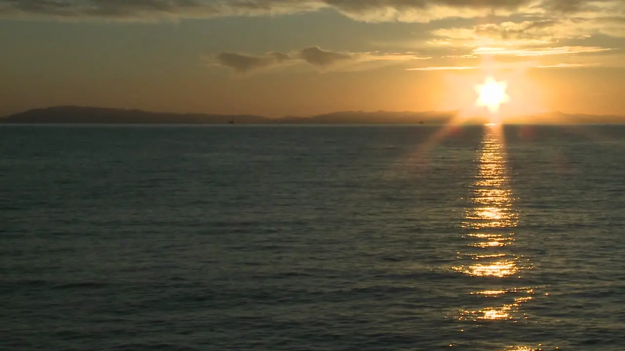 Pan of the sun setting over the Channel Islands and the Pacific Ocean at Ventura California