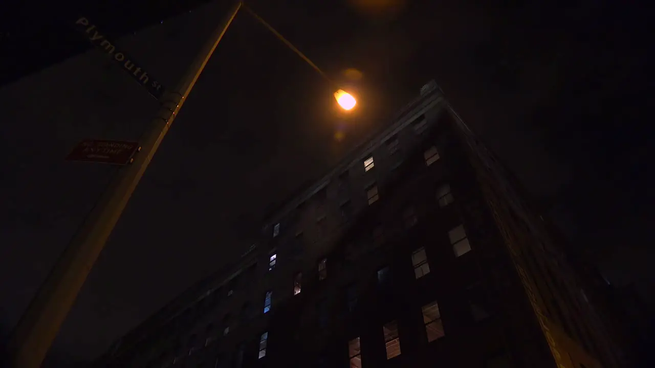 Wide low angle shot of a New York or Brooklyn apartment complex in a warehouse district at night 1