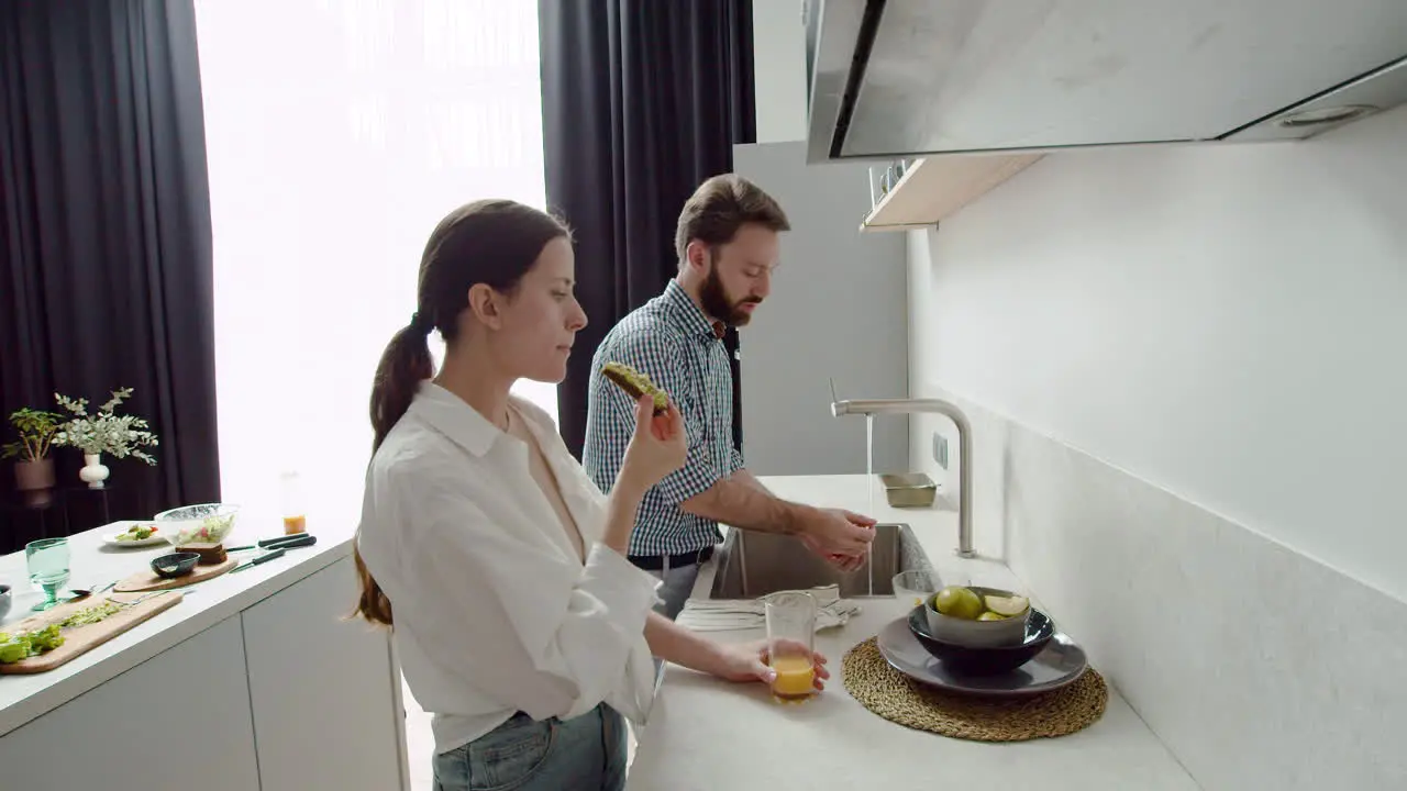 Couple Chatting Together In A Modern Kitchen