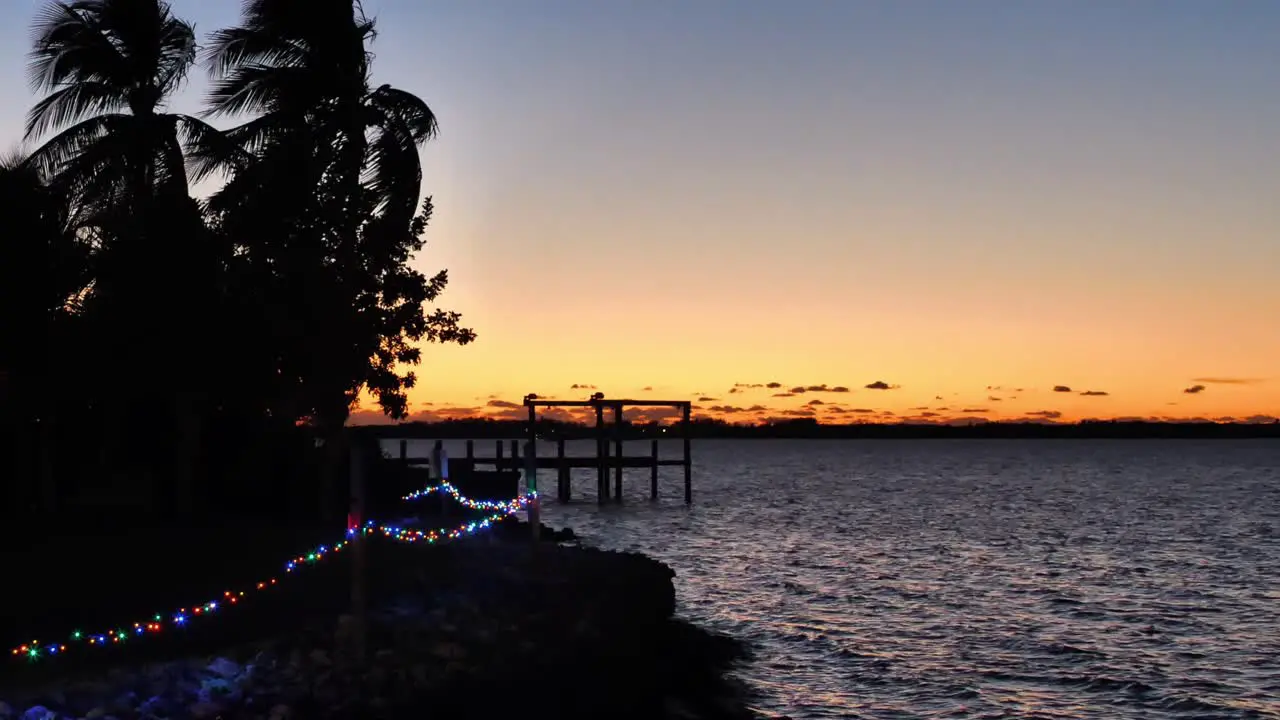 Rippling Water at Sunset near Pier with string of Lights