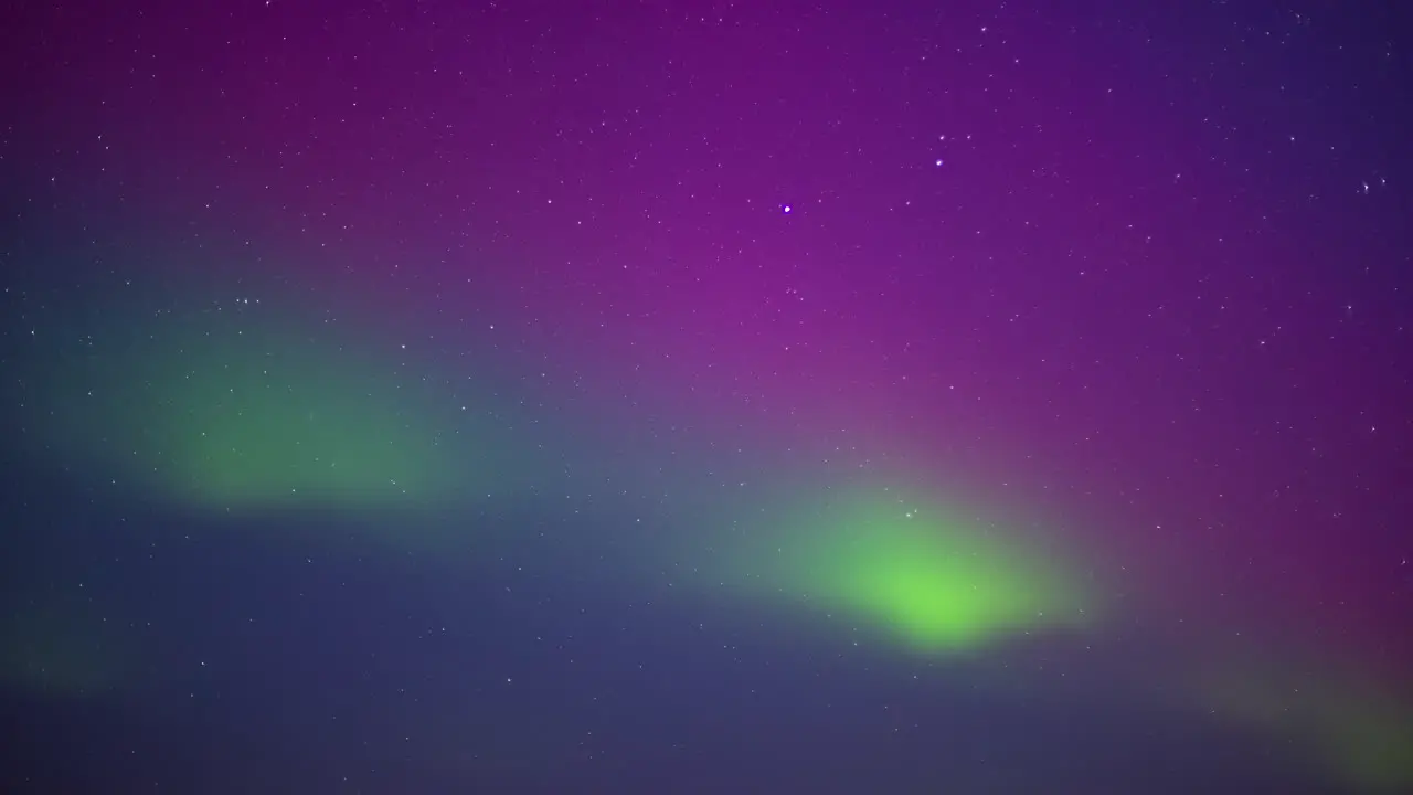 Stars and the vibrant colors of the aurora borealis sky only time lapse