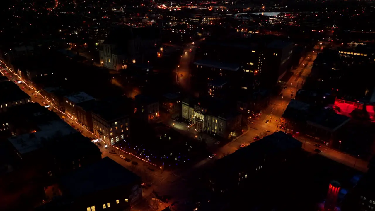 City Of Sherbrooke Illuminated With Lights During Nighttime In Canada aerial pullback