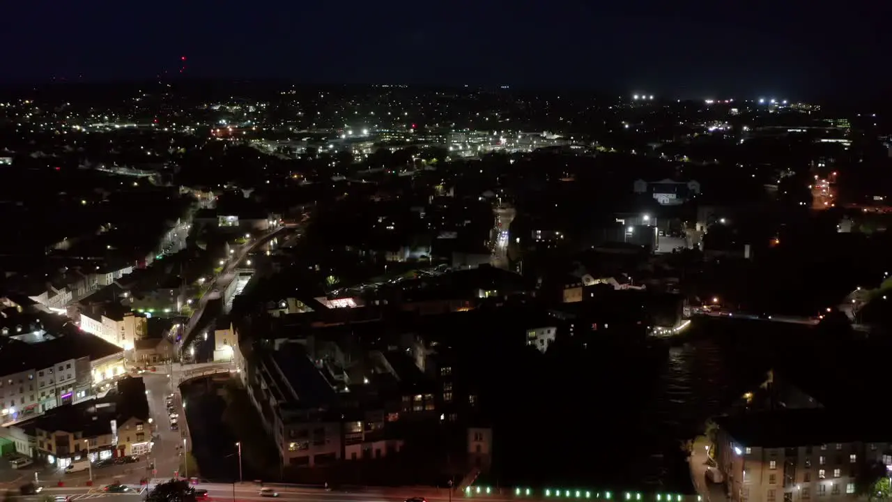 Long reverse dolly of Galway night life following the path of the River Corrib