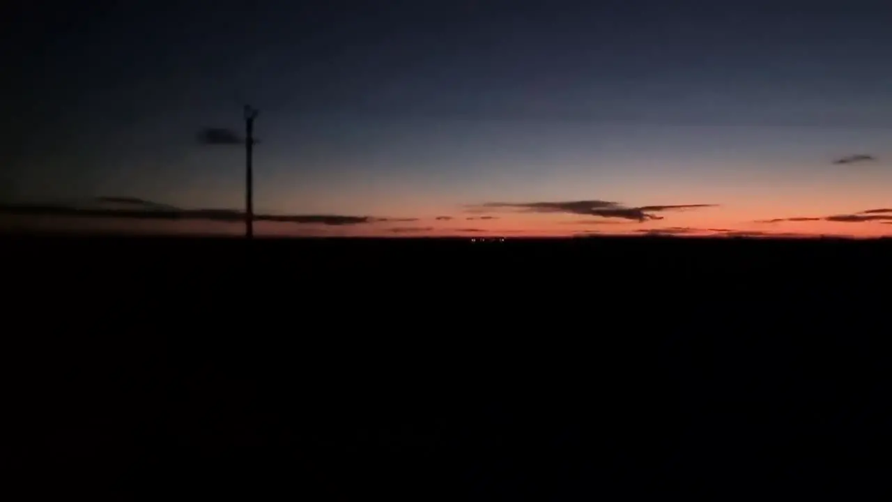 Driving in rural field area during sunset evening night