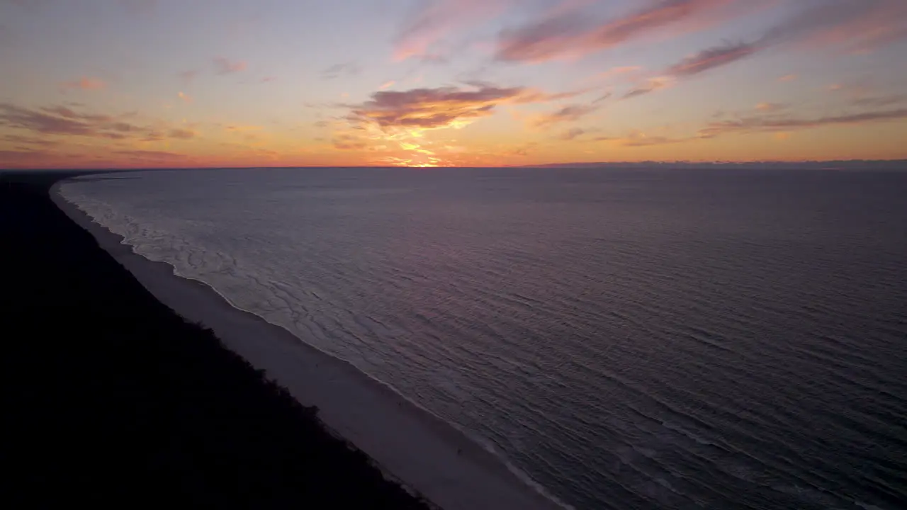 Colorful sunset on horizon at Baltic Sea Krynica Morska beach aerial