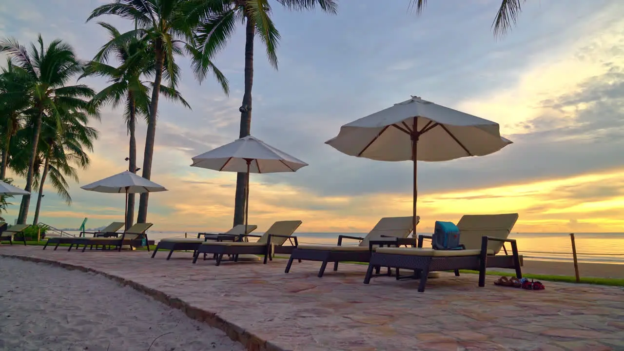 Umbrella and chair around swimming pool in resort hotel for leisure travel and vacation neary sea ocean beach at sunset or sunrise time