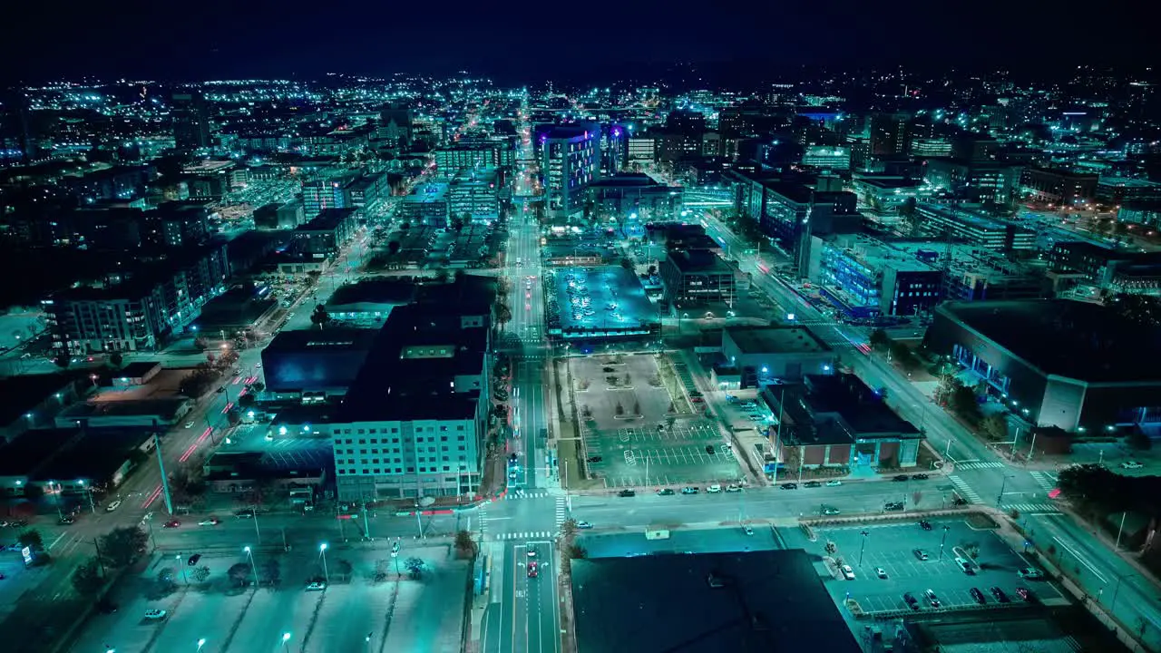 The vibrant city lights of Birmingham Alabama illuminate the skyline and streets in this nocturnal high tech aerial view