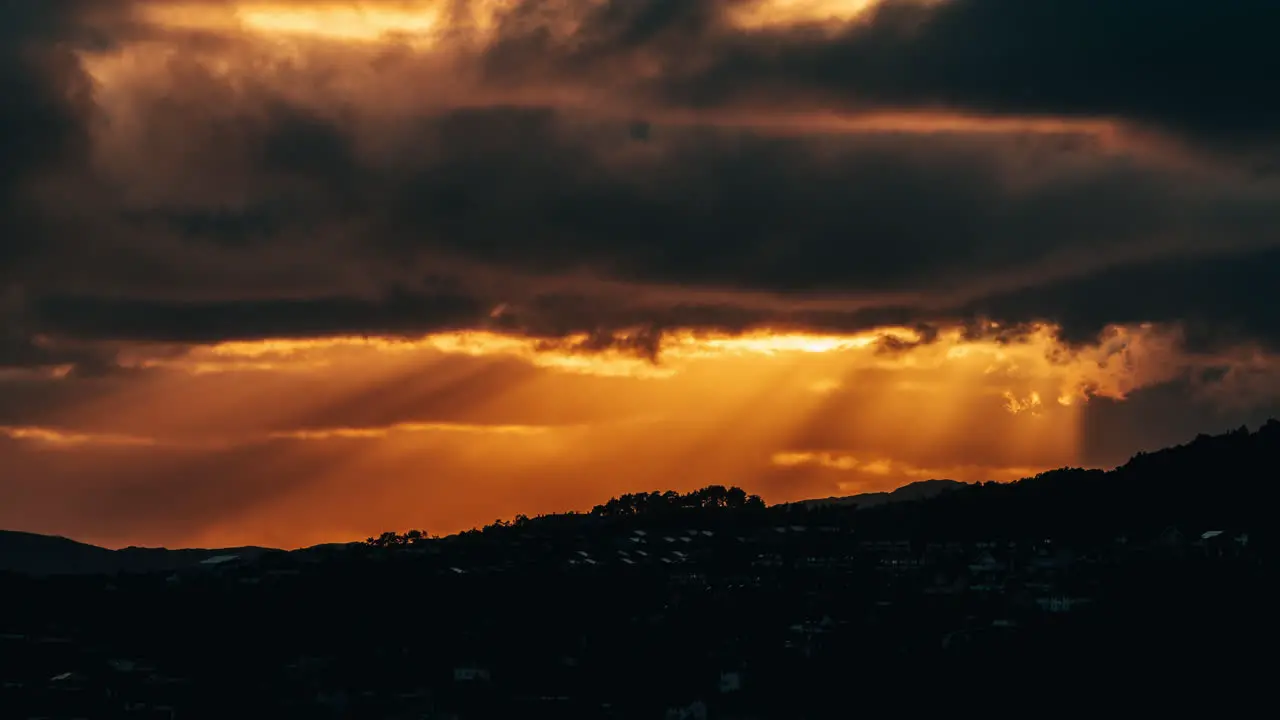 Stunning timelapse shot of golden sunrays appearing through the clouds