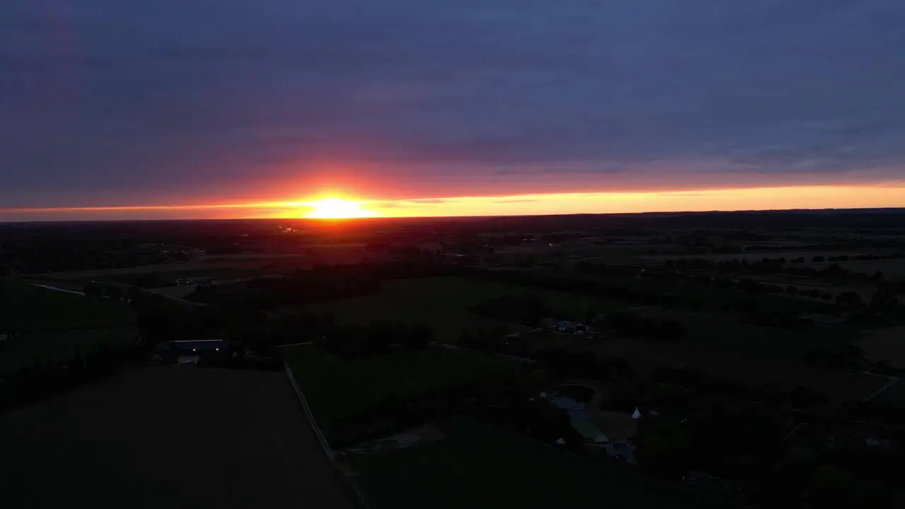 Dramatic Golden Orange Sunset Sky On Horizon With Silhouette Landscape View