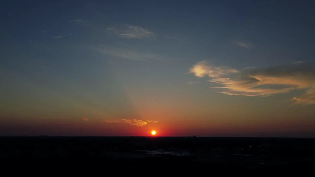 Aerial drone view of beautiful sunset blue sky and few clouds with aeroplan flying in the sky