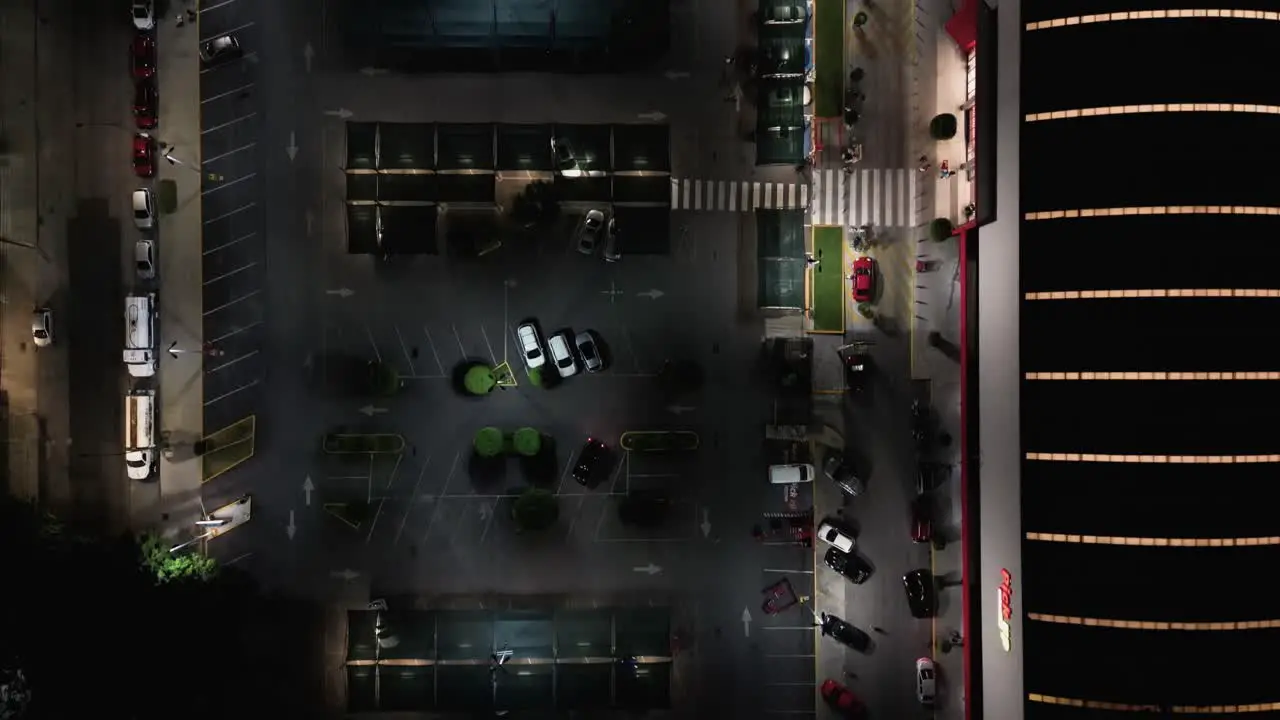 Nighttime flyover of a shopping mall parking lot in the Del Valle neighborhood in Mexico City