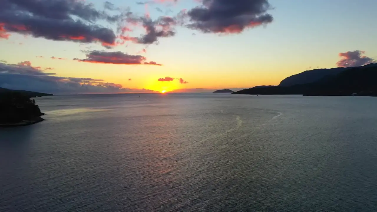 Aerial drone shot towards the sunset over the lake-1