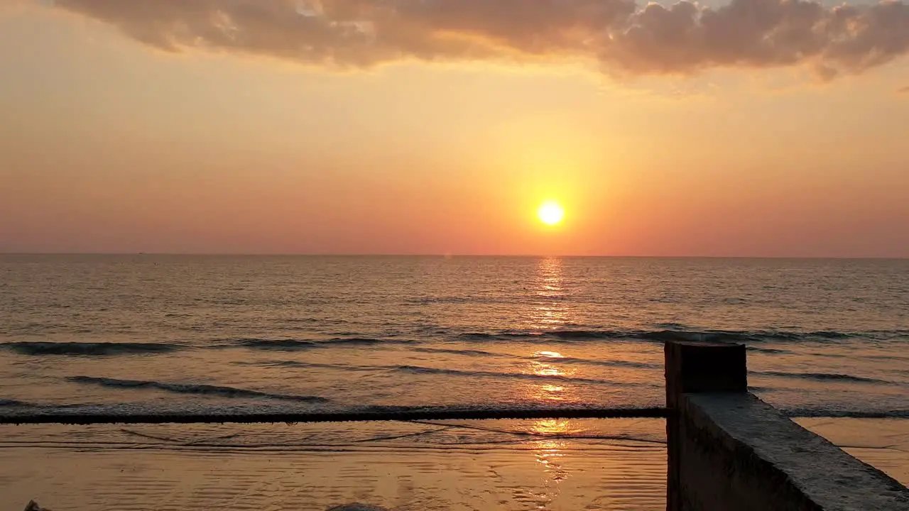 Stunning sunset over beach with calm waves coming into the beach