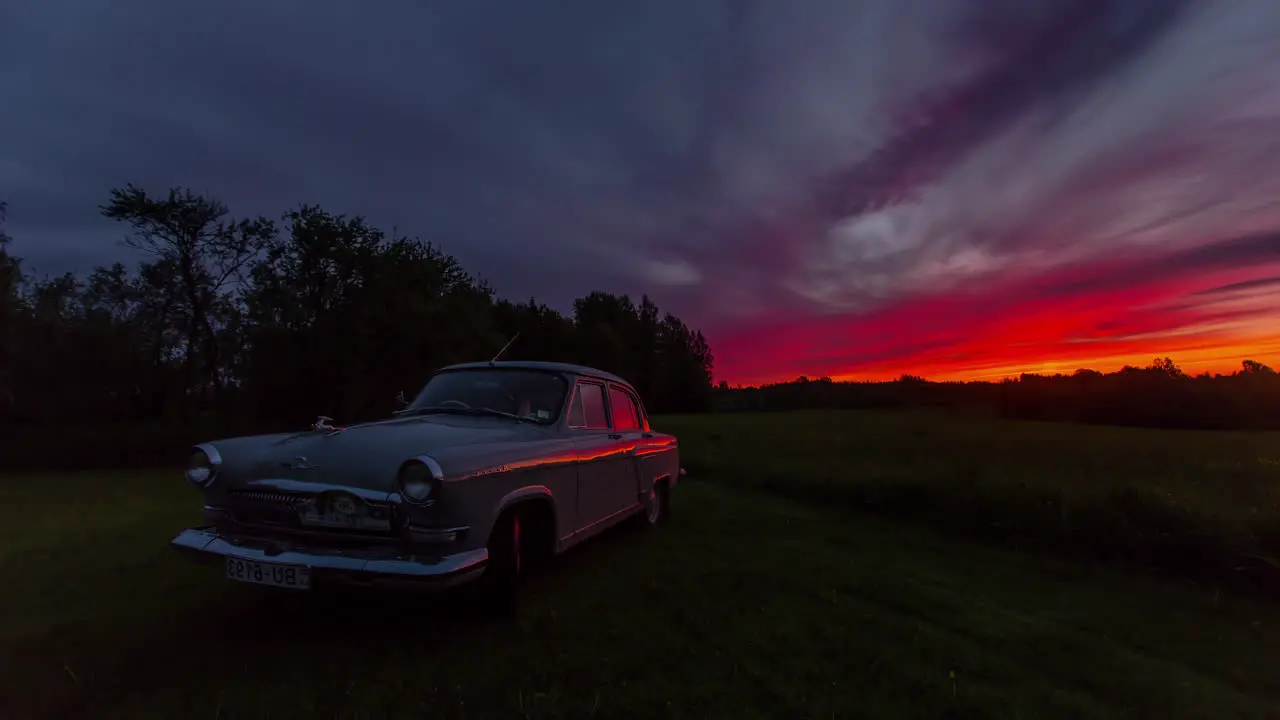 Old historic Gaz 21 car standing on a grassy clearing