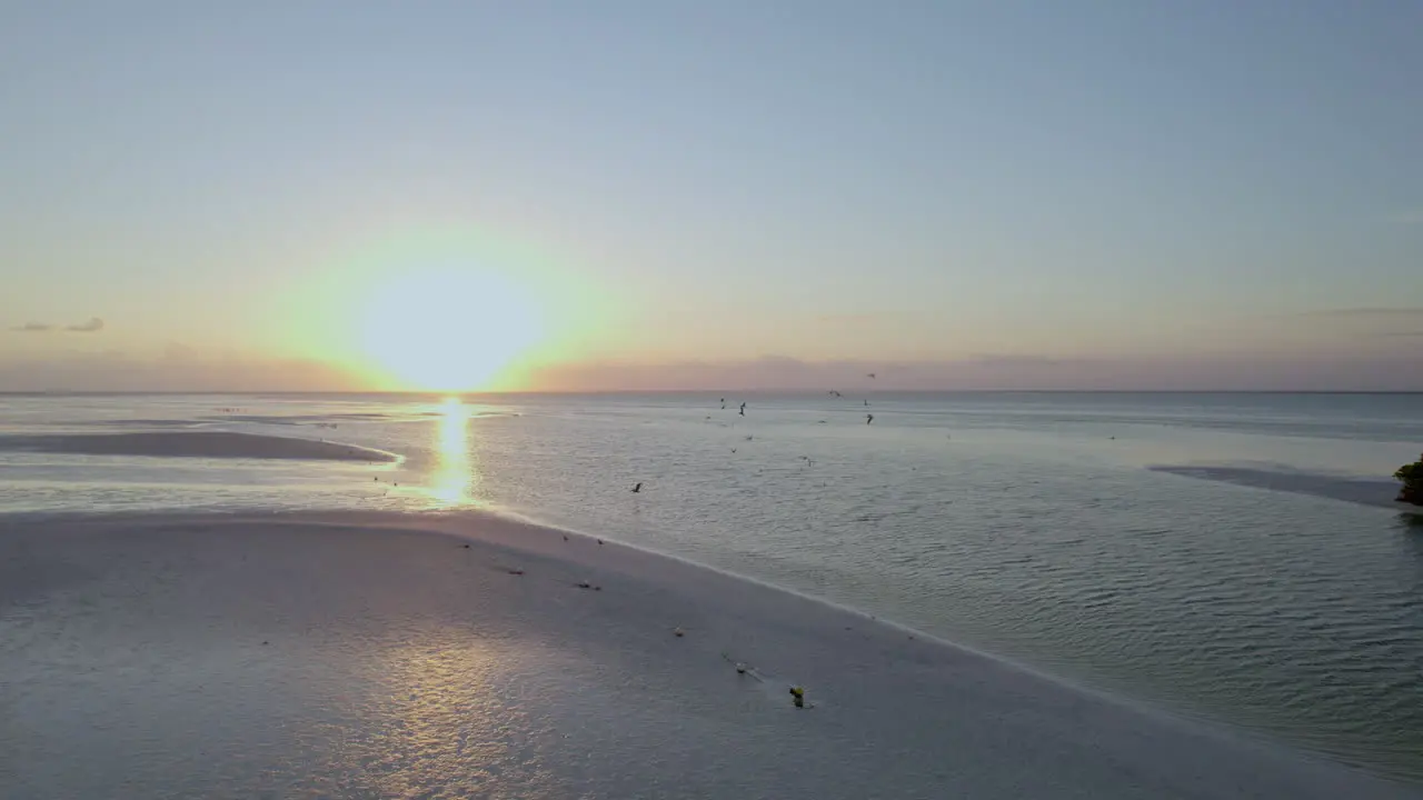 Drone shot view of the ocean with sunset sky