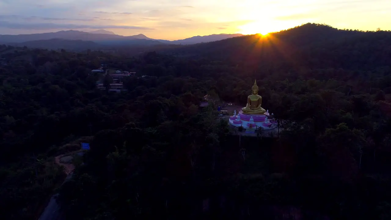 Aerial Giant Buddha Flyover Jungle Sunset Sun Rays Drone Laos Tourism Sunrise Tropical Palm Trees