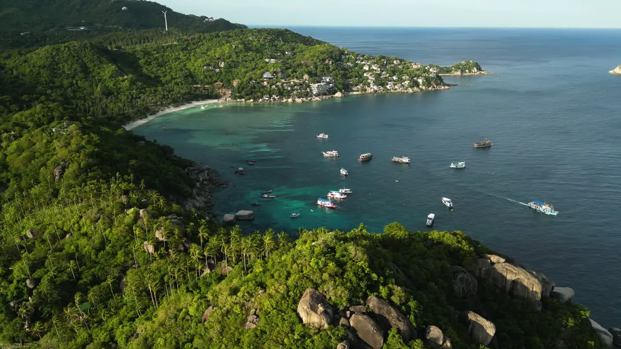 Aerial view of Shark bay Koh Tao Thailand south east Asia famous spot for scuba diving class boat moored at bay scenic seascape and pure unpolluted nature with warm sunset light