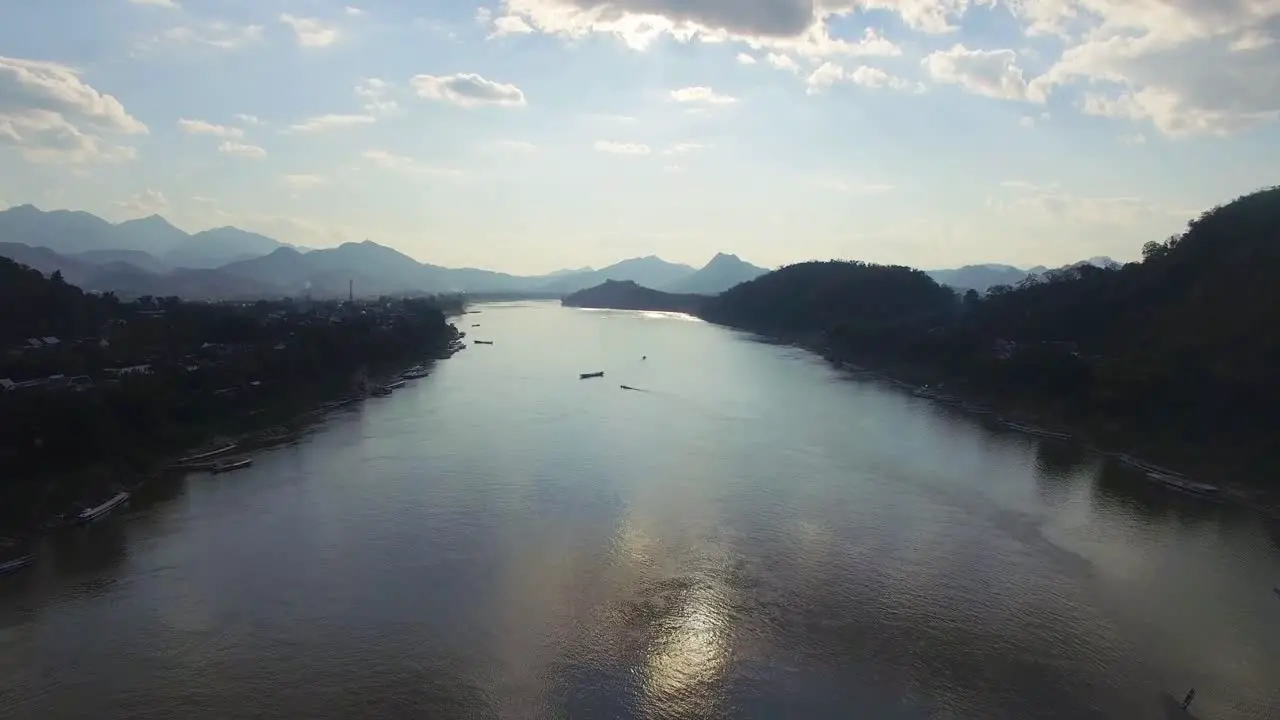 A drone shot at sunset above the Mekong River in Luang Prabang Laos