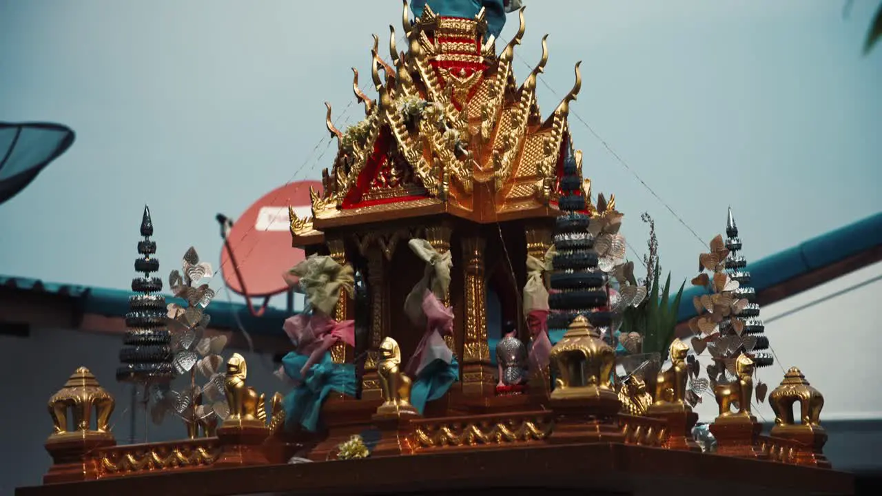 Close up of a spirit house in a garden in Thailand