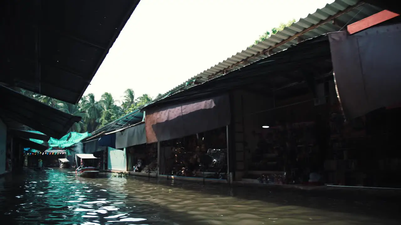 Small vendors and shops along the canal in Thailand