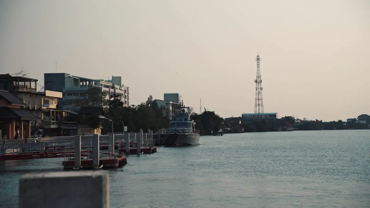 A small warship berthed along the Maeklong River