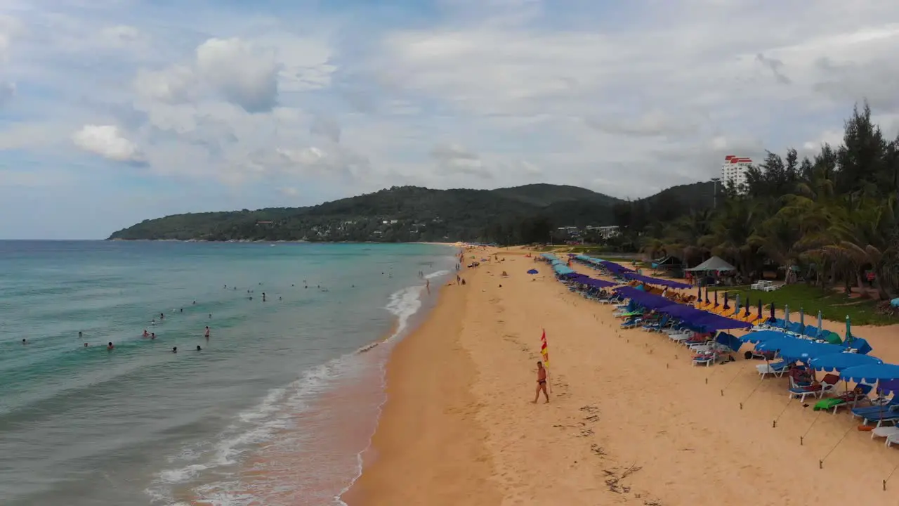 Zipline aerial drone shot of Karon beach a popular public beach among local and foreign tourists located on the island of Phuket in Southern Thailand