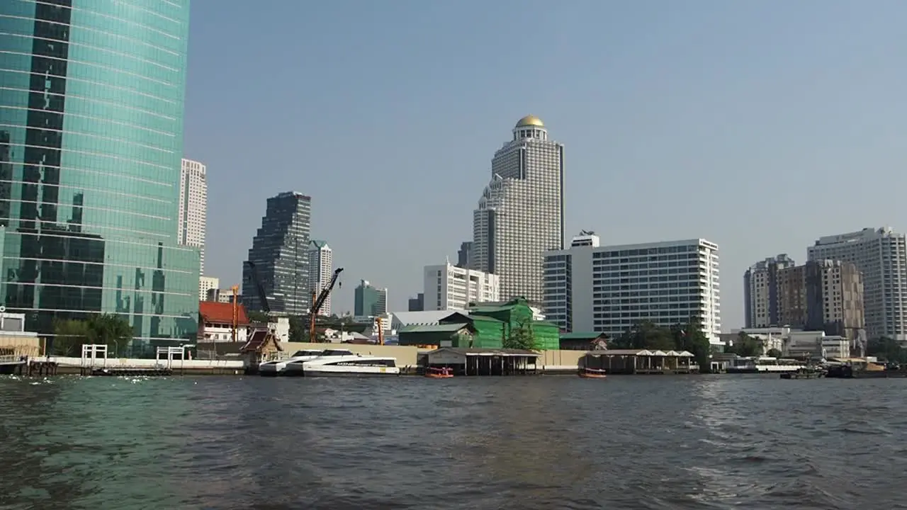 Bangkok City view from the Boat cruise on river Chao Phraya in front of Icon Siam mall with buildings in front Thailand