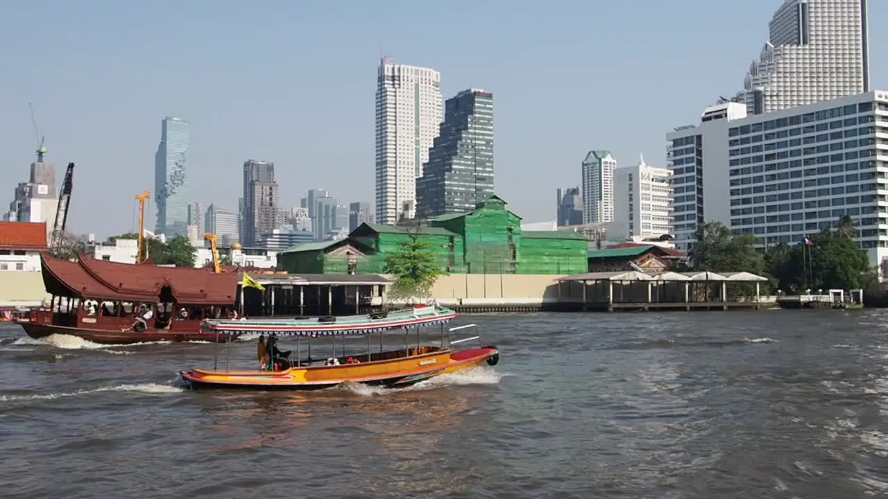 Bangkok City view from the Boat cruise on river Chao Phraya in front of Icon Siam mall with buildings in front MahaNakhon tower Thailand