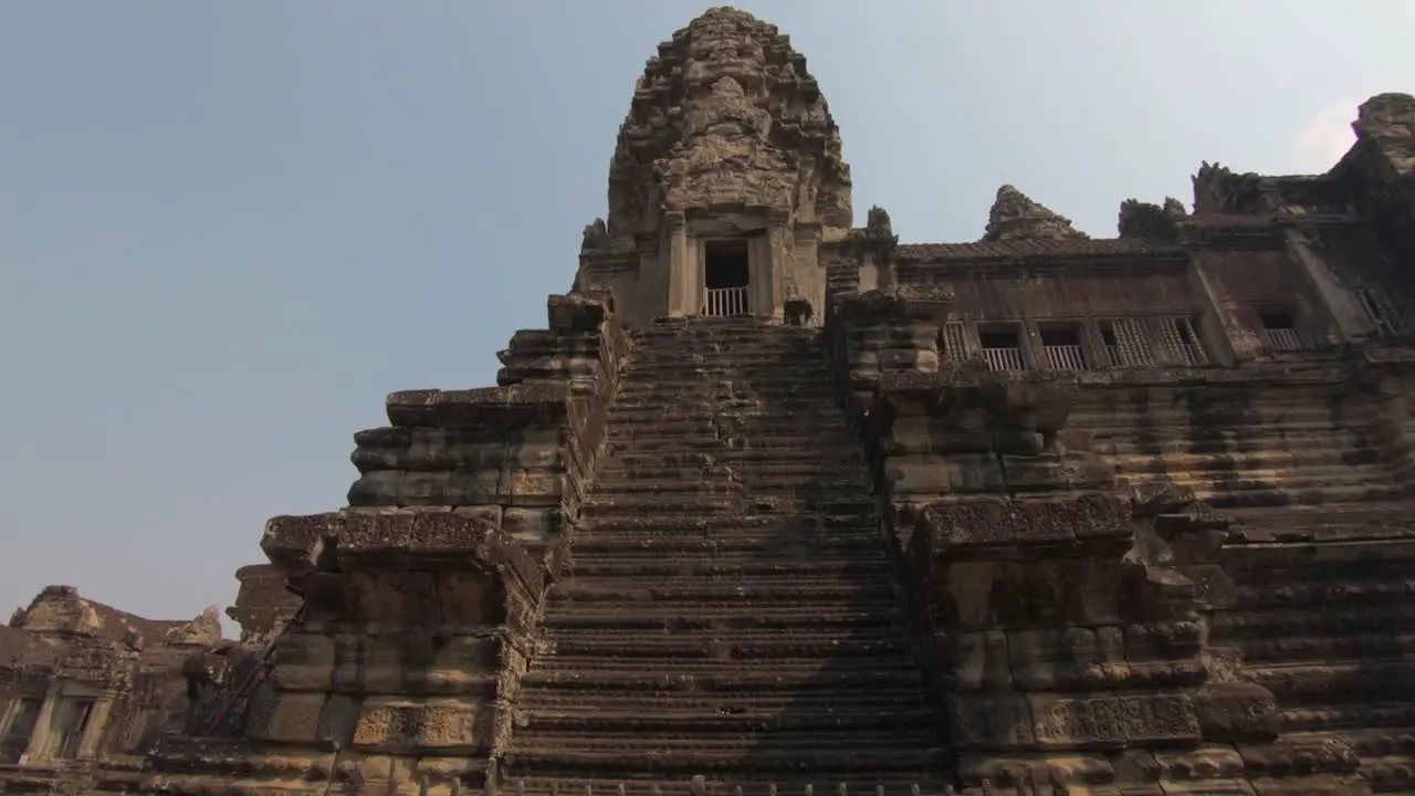 Slow downward pan of a staircase that's part of the ancient temples of Angkor Wat Cambodia