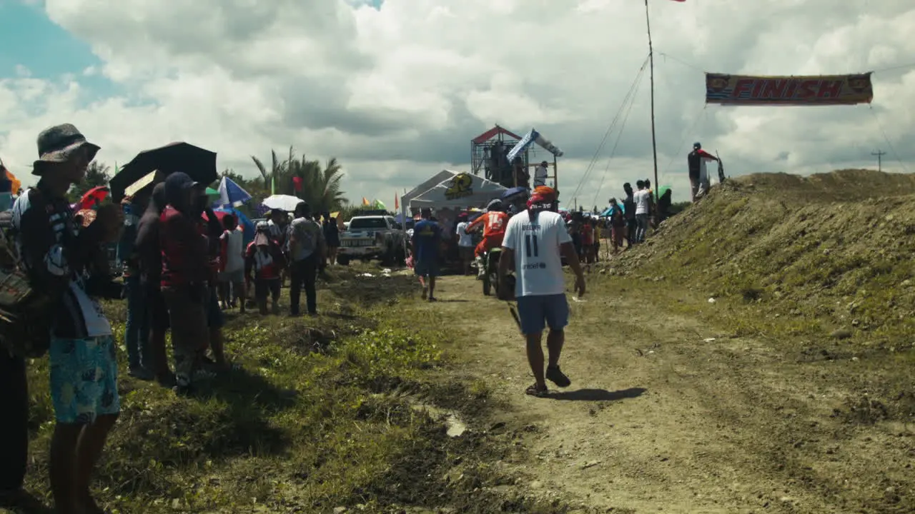 Participants leave the race track as the next race of the anticipated motocross competition begins