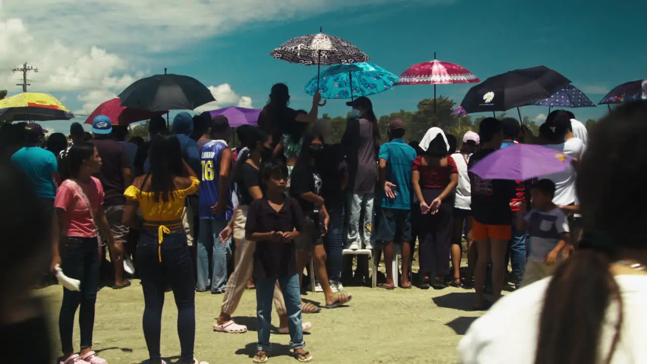 Crowd gathers near the race track on day 2 of the motocross competition