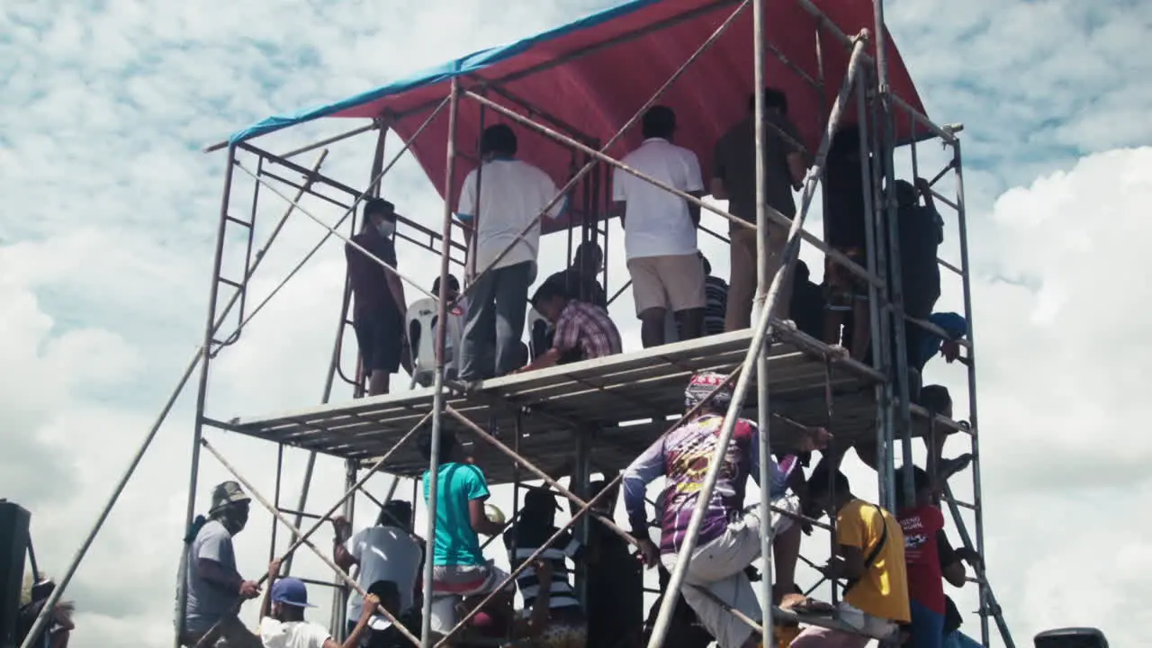 Onlookers public officials and the media gather on a small scaffolding to get a better view of the motocross competition