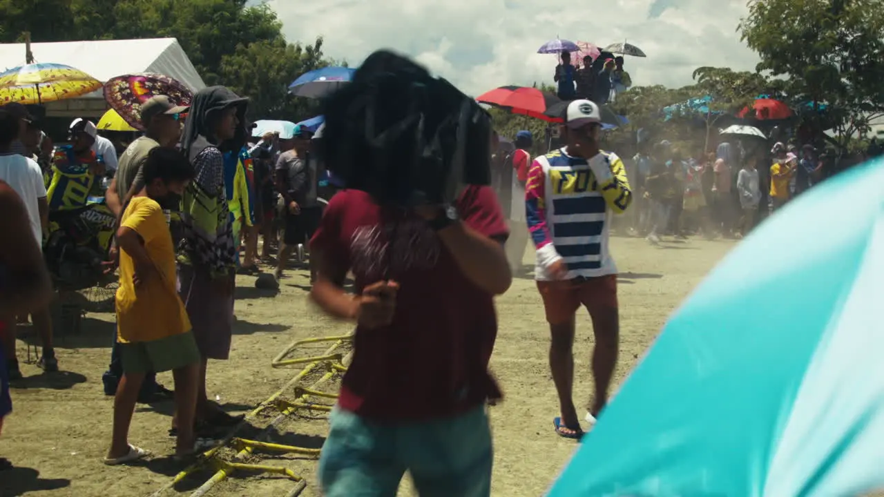 Motorcycles zoom from the starting line as motocross competition proper begins