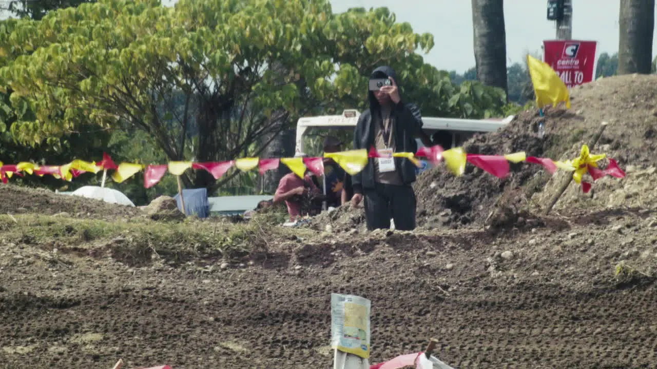 Motocross competition staff take photos before the competition proper starts