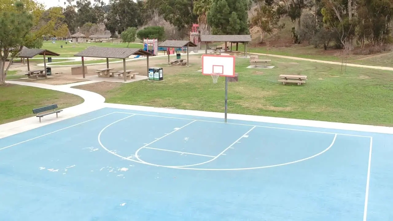 Empty basketball court at the park during the day