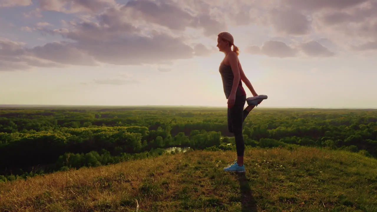 Young Woman Doing Stretching Exercise In An Epic Beautiful Place At Sunset