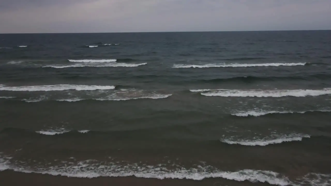 Cresting storm waves lapping on the shore