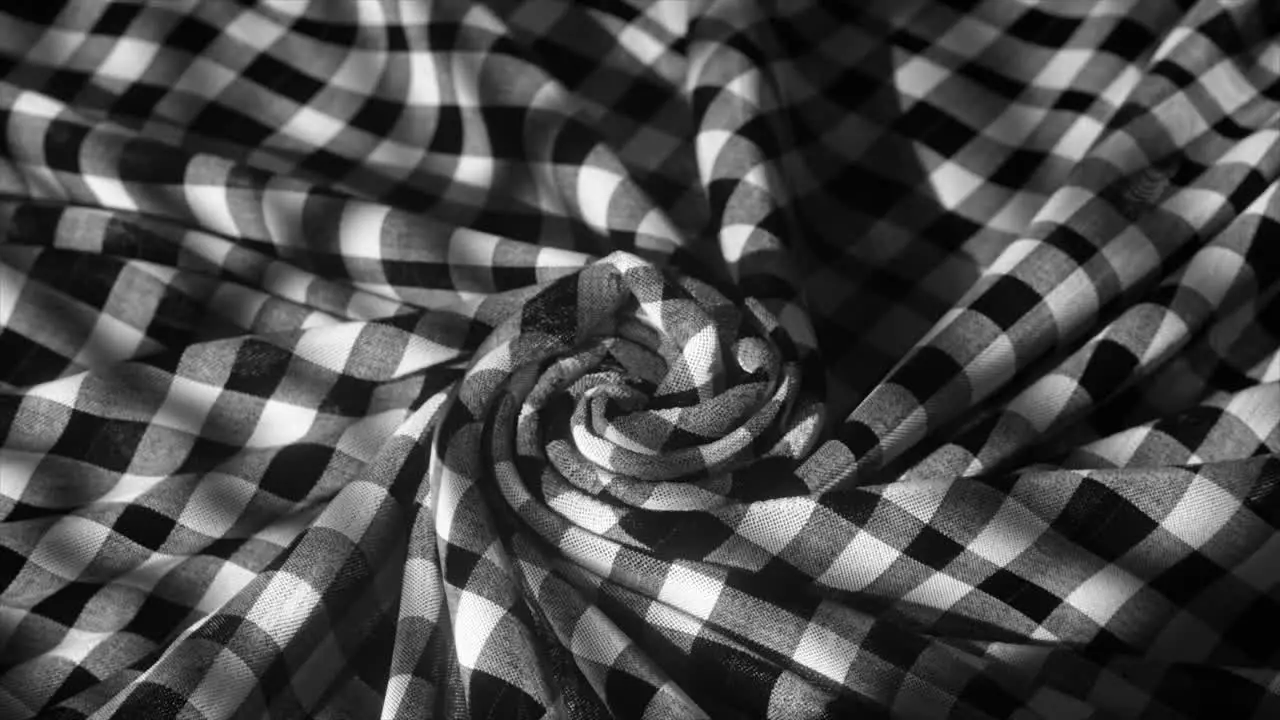 A Monochromatic Checkered Fabric Spirals Into a Hypnotic Pattern Evoking a Classic yet Contemporary