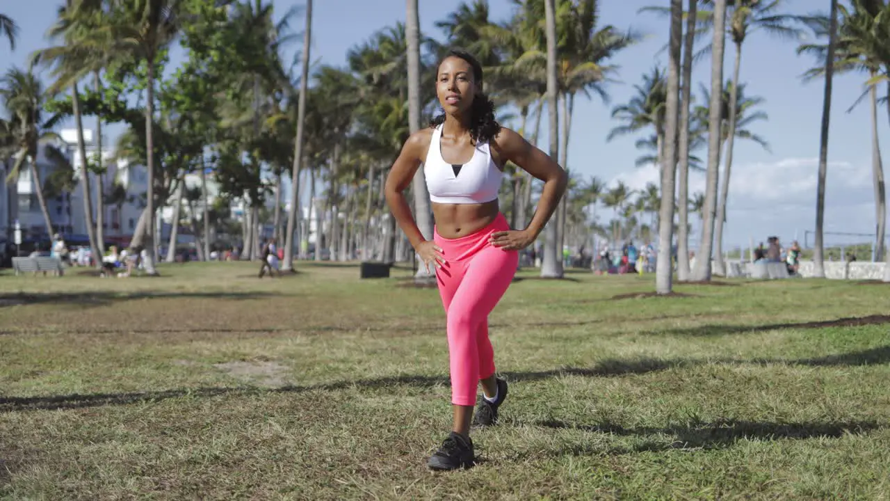 Confident woman working out on meadow