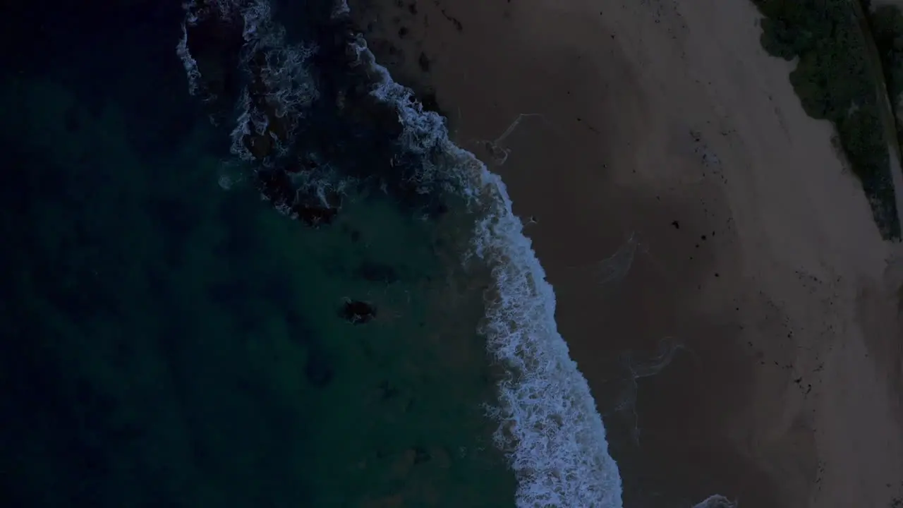 Waves crashing during blue hour at laguna beach in Southern California