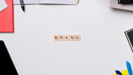 Stop Motion Business Concept Above Desk Wooden Letter Tiles Forming Word Brand