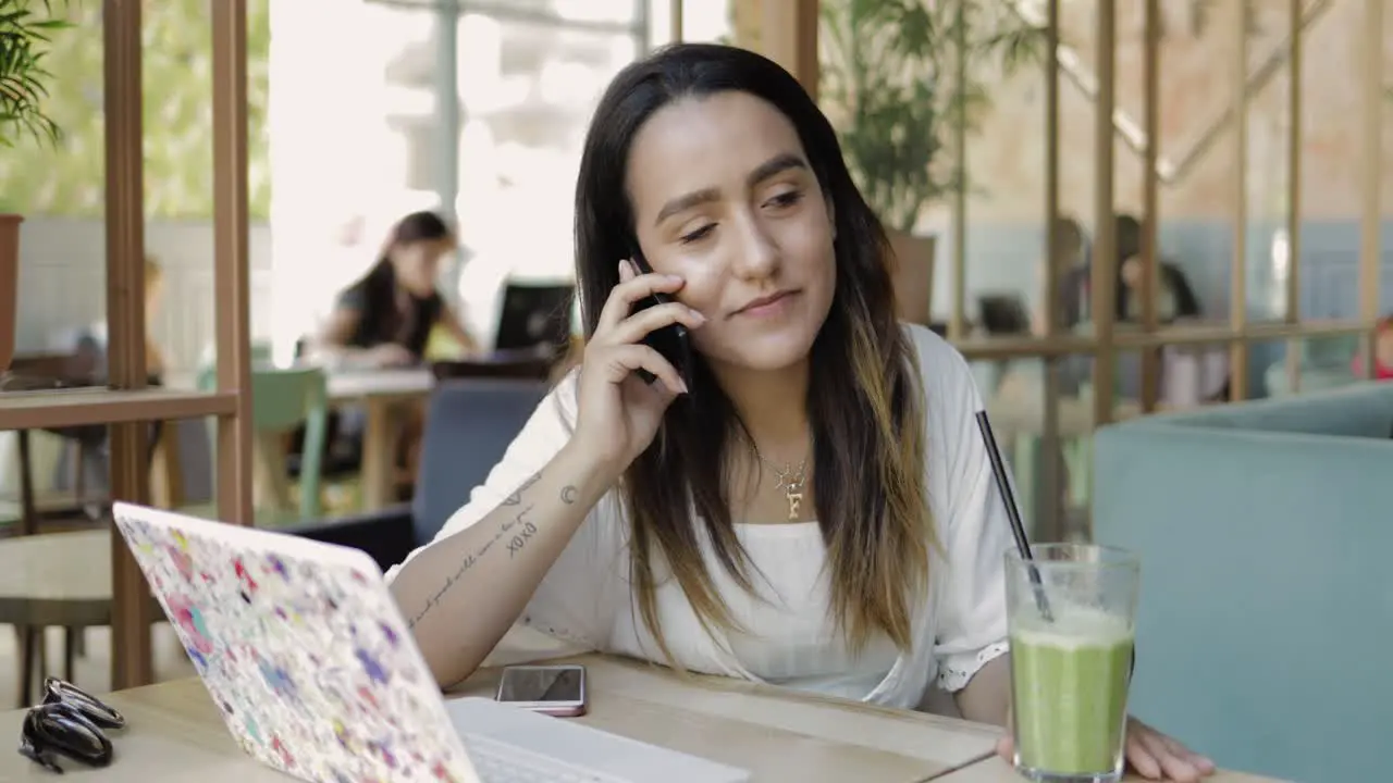 Young woman sitting listening to a mobile call