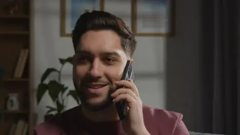 Pleased Young Man At Home Receiving Phone Call Confirming Job Offer 5