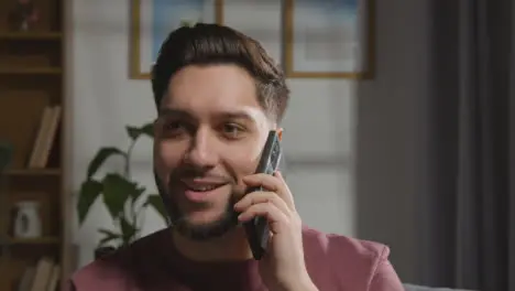 Pleased Young Man At Home Receiving Phone Call Confirming Job Offer 3