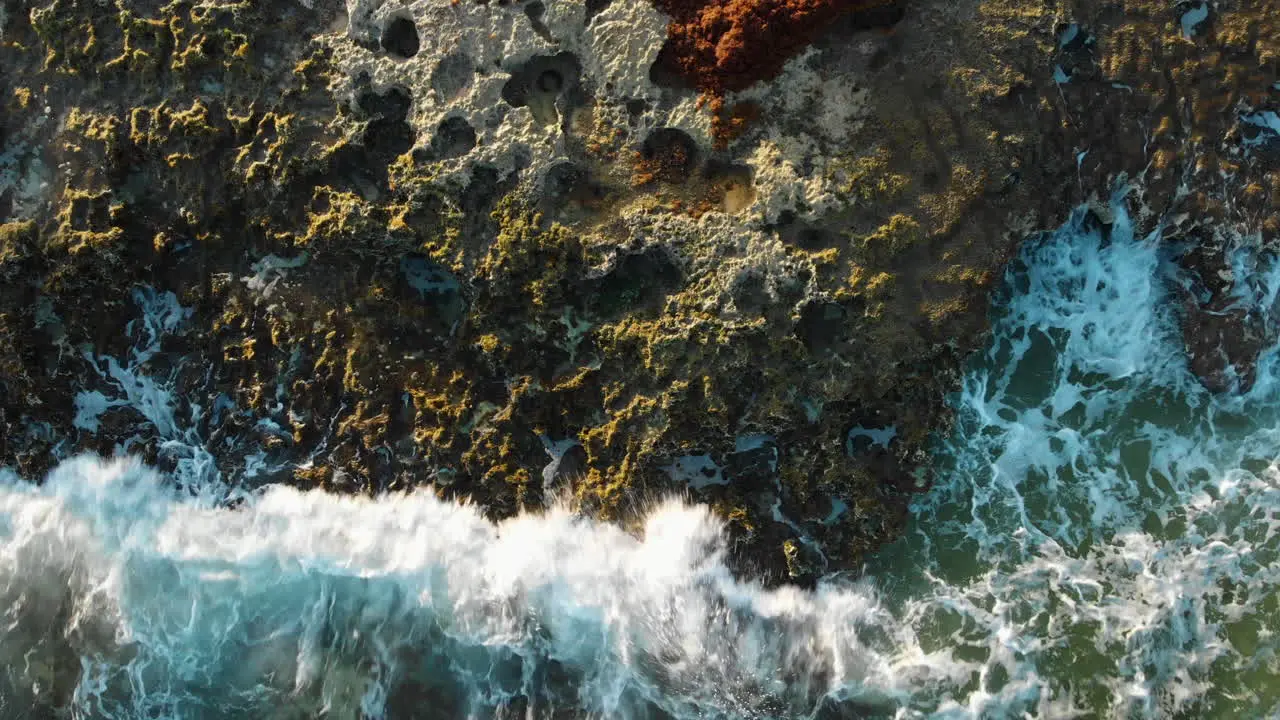 Drone shot of crashing waves on rocks in Mexico ocean