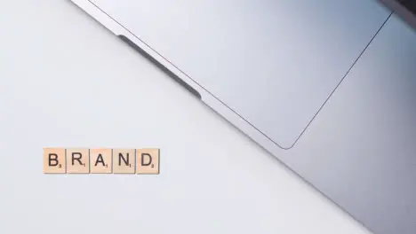 Stop Motion Business Concept Above Desk Wooden Letter Tiles Forming Word Brand 1