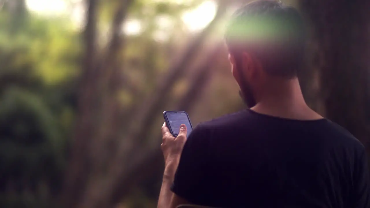 Cinematic shot of male asian model looking for a message on his smartphone by scrolling