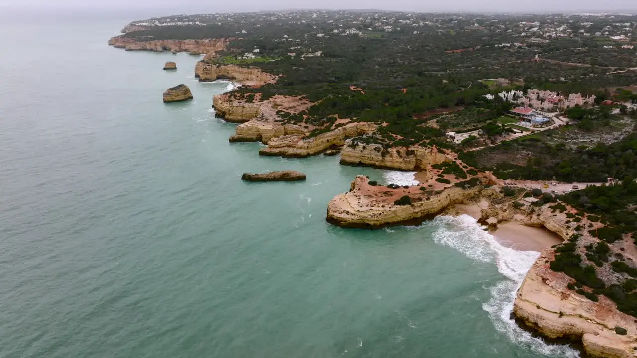 Flying over the Algarve Coast on a cloudy day slowly showing off the whole coastline