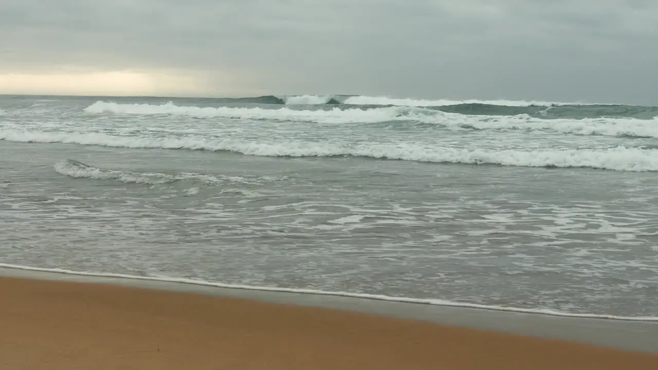 Panning shot of Waves and clouds in the distance