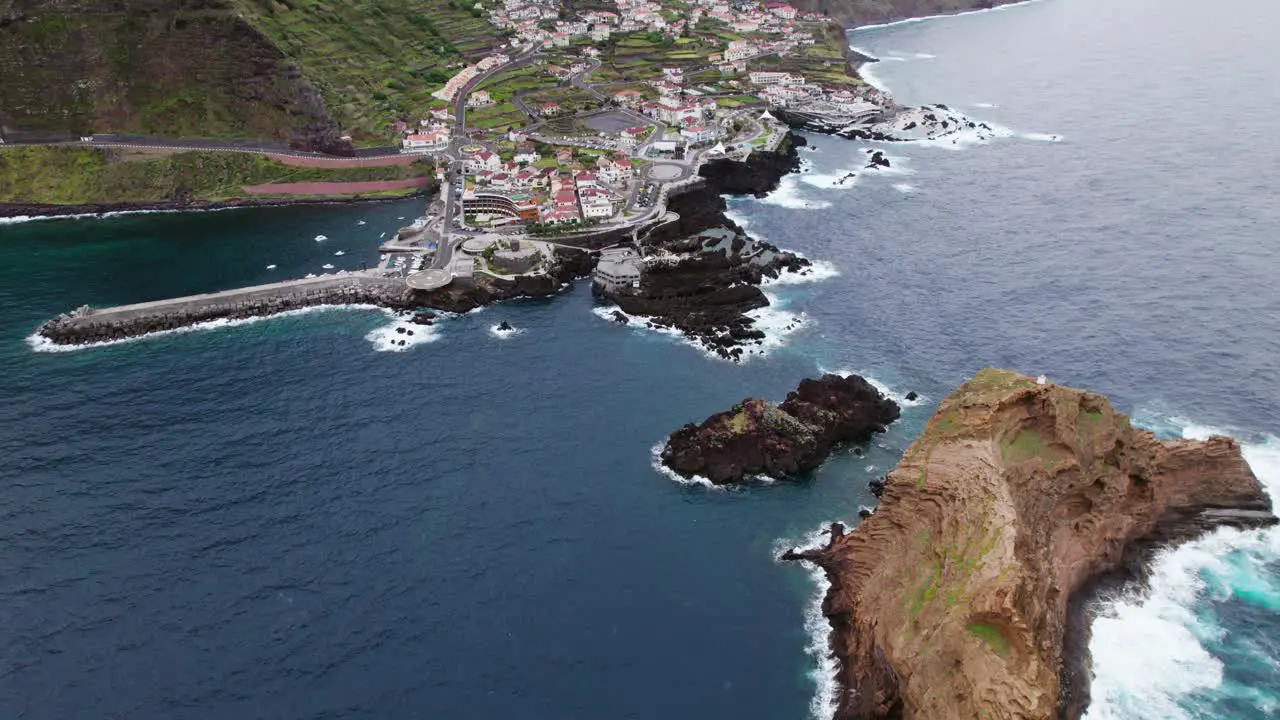 drone view Small town near coast in Madeira rocky cliffs cloudy weather Portugal